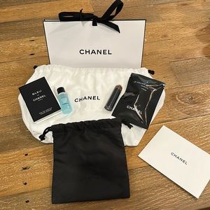 Chanel brush, mascara, cologne, makeup remover, and 2 pouches